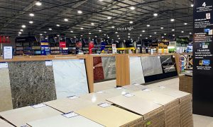 Spacious industrial warehouse with tiles and construction materials on display, suitable for home renovation.
